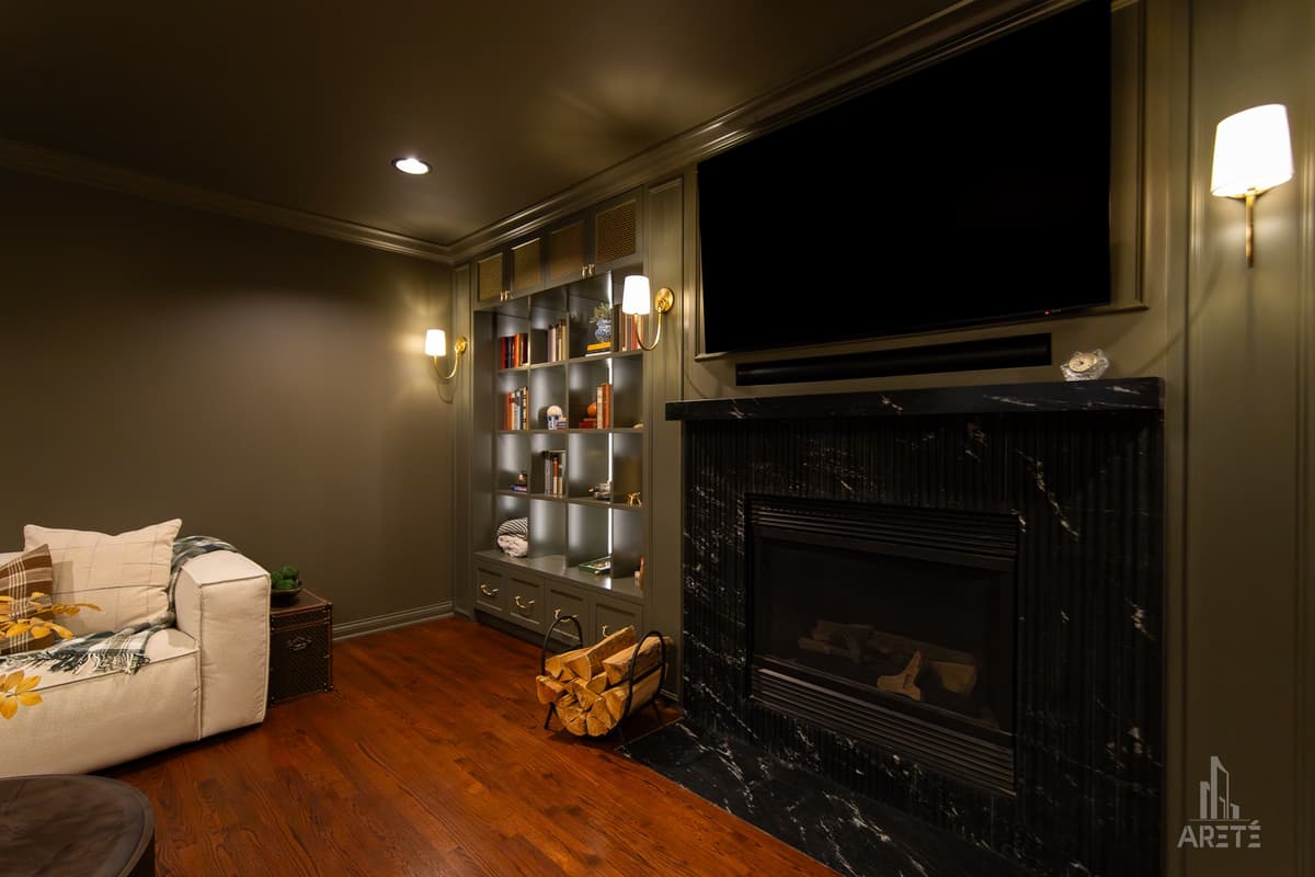 Finished basement media wall with fireplace and built-in shelving