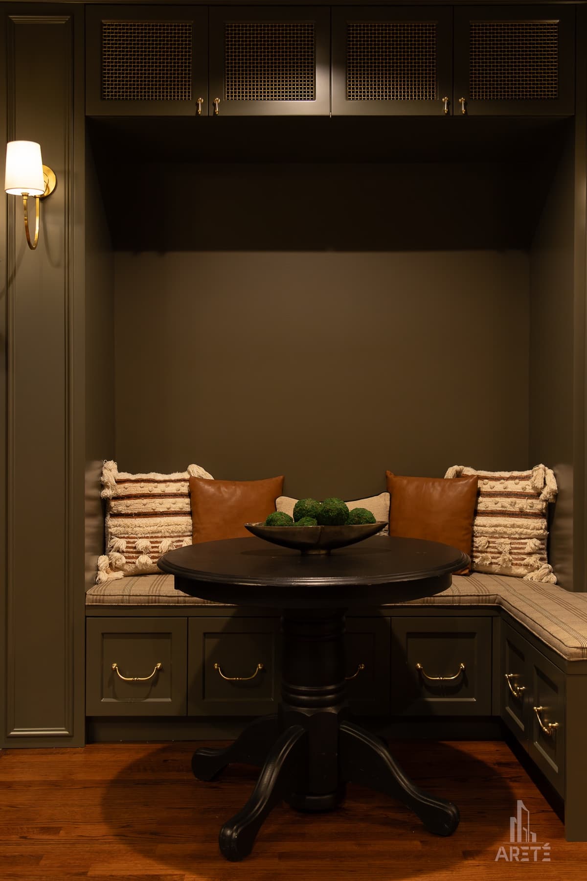 Finished basement nook with built-in bench seating and a round table