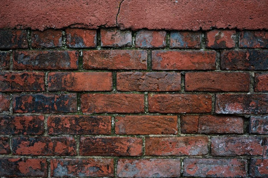 crumbling mortar joints showing signs of water damage