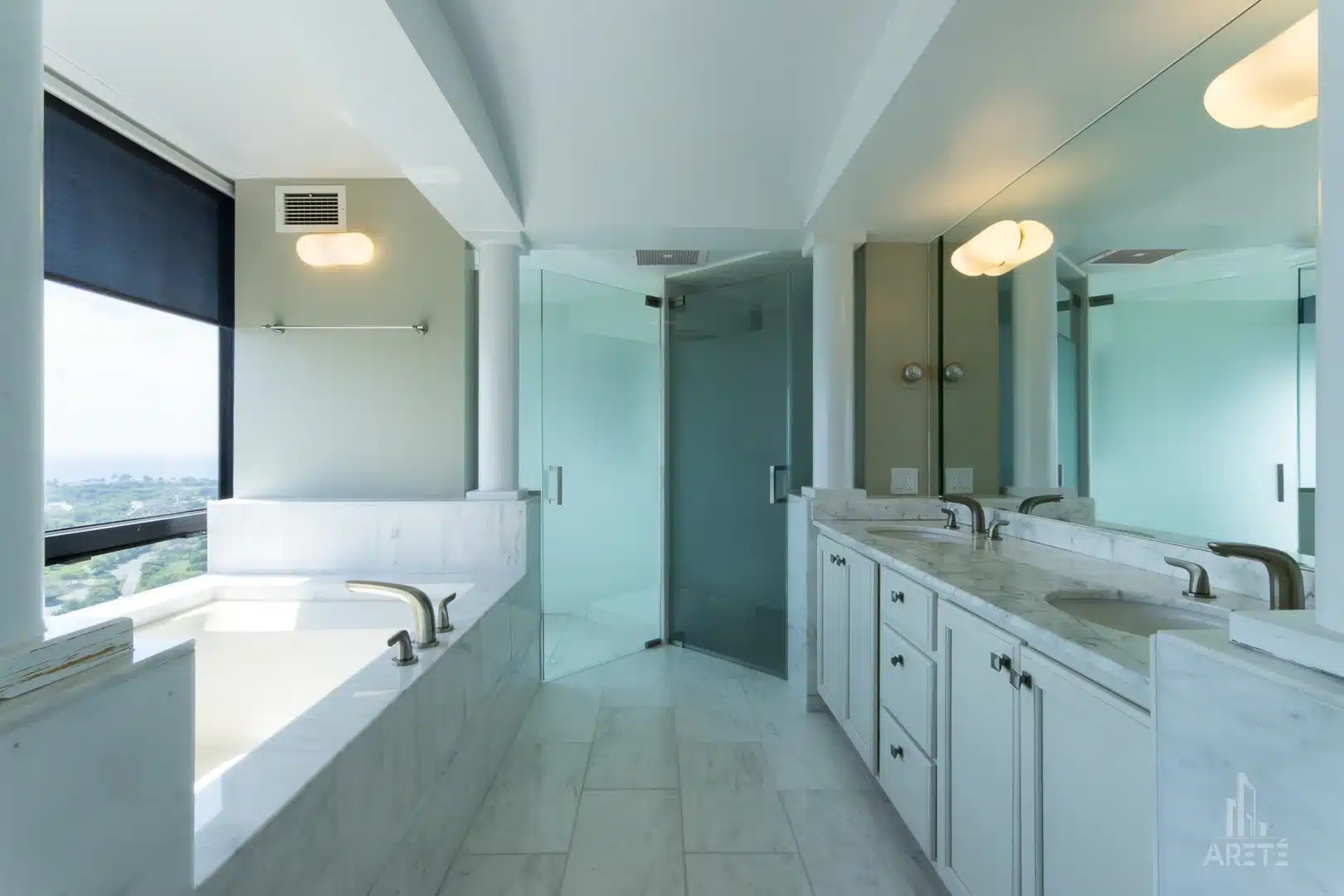Luxury Chicago bathroom design with a window view of the cityscape directly over the bathtub.