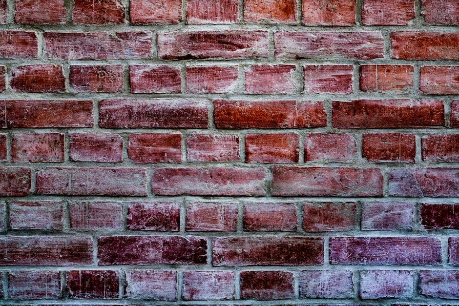 crumbling mortar joints and efflorescence on chicago brick wall
