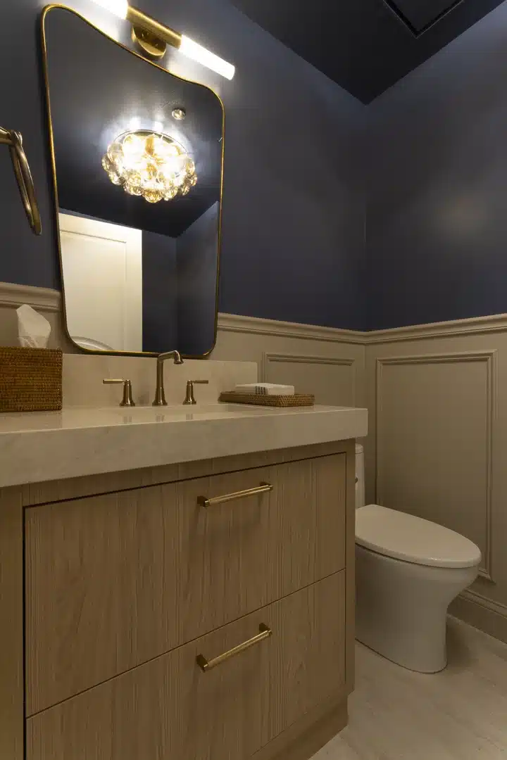 beautifully remodeled bathroom featuring a classic off-white chair rail and wainscoting