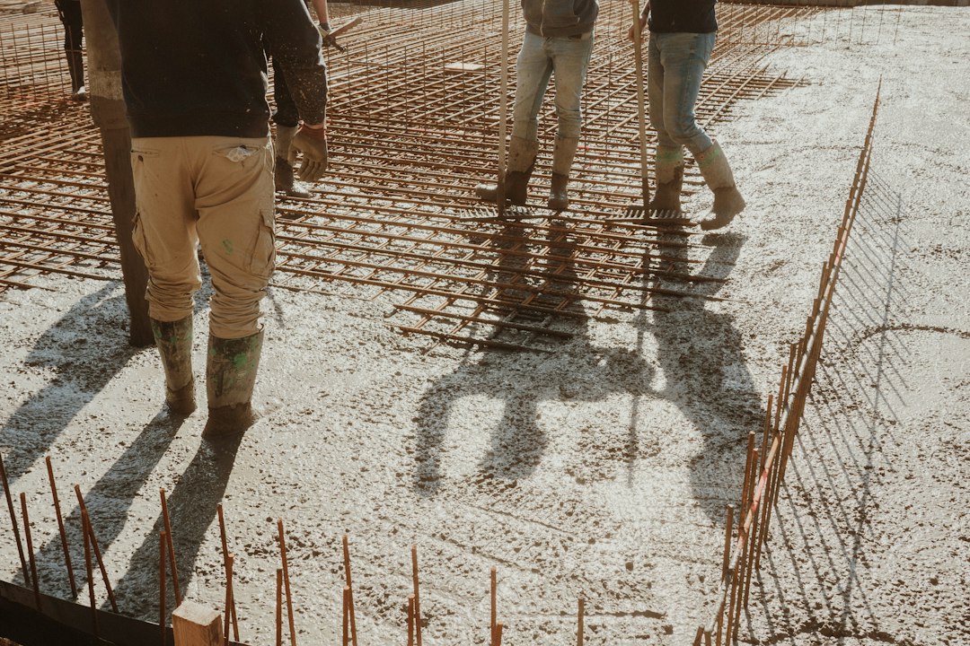 Construction crew pouring concrete slab foundation Chicago winter